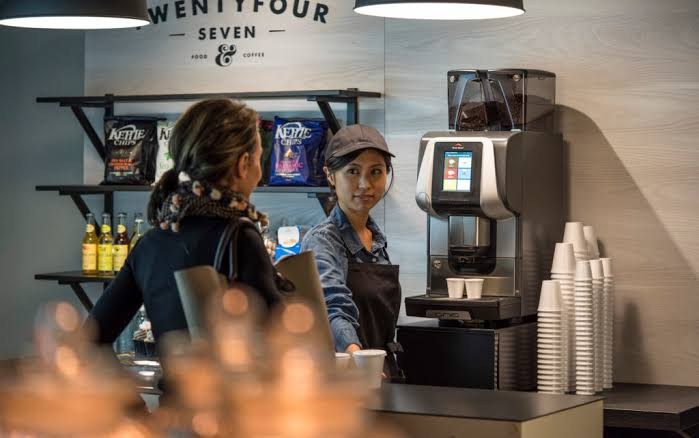 An Egro One in daily service on a food and coffee counter, with staff serving a customer