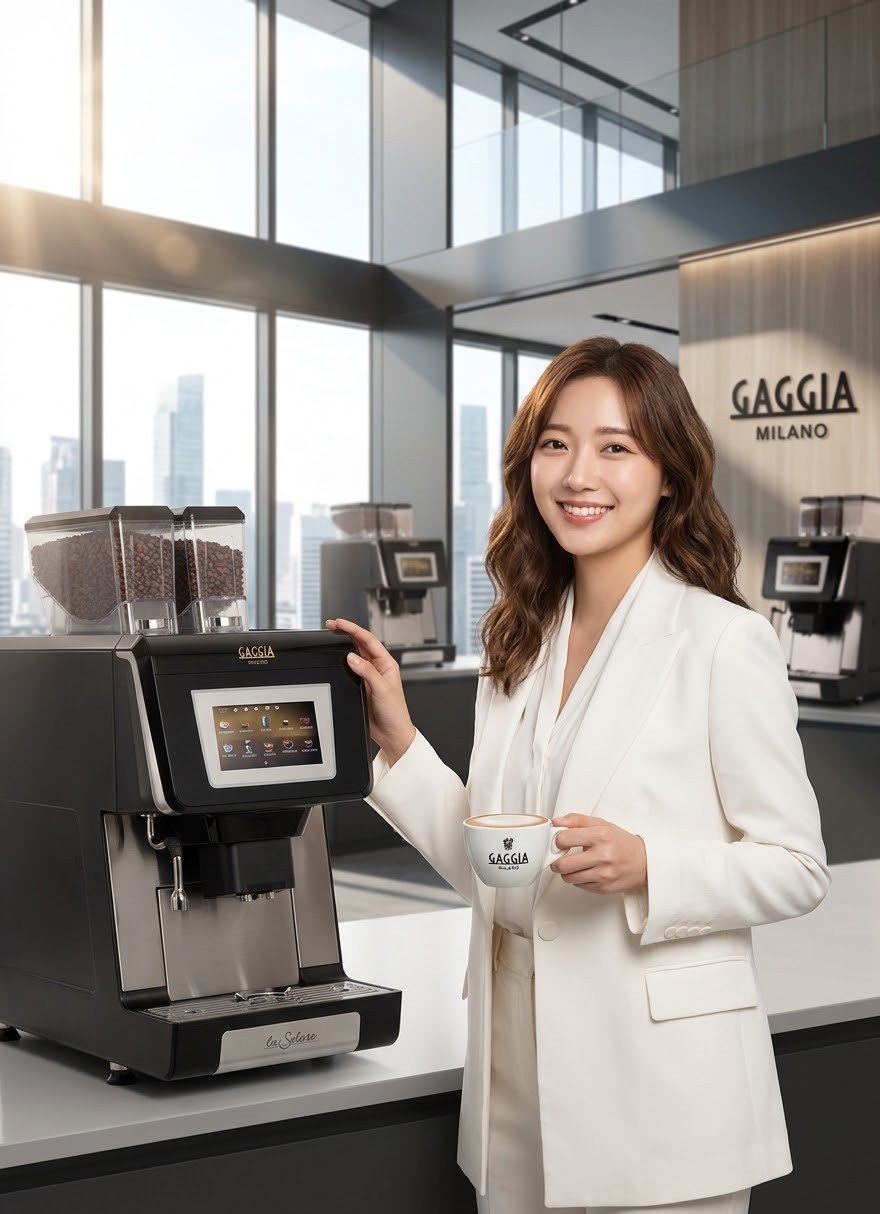 A Gaggia La Solare fully automatic coffee machine on a counter in a modern office lounge, with Gaggia Milano branding behind