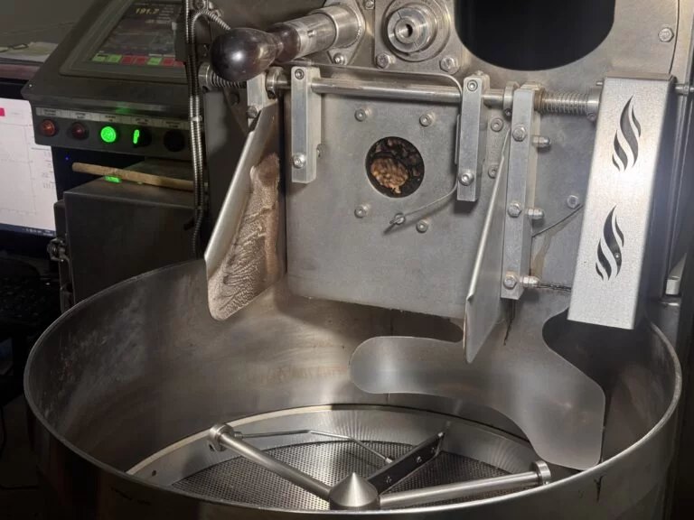 Freshly roasted coffee dropping into the cooling tray of the Loring roaster